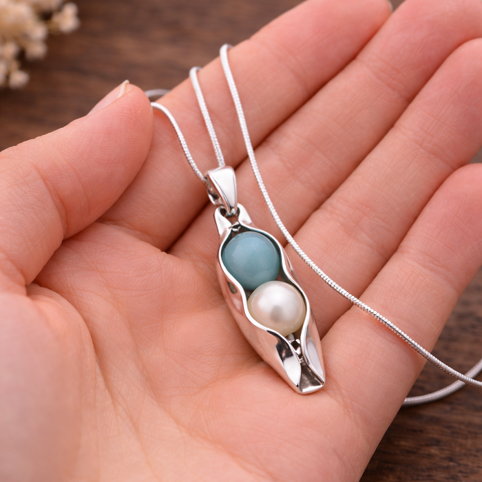 two peas in a pod anniversary gift necklace on hand