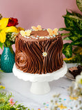 Chocolate Forest Fantasy Cake with rustic chocolate buttercream, sugar butterflies and blossom sprinkles