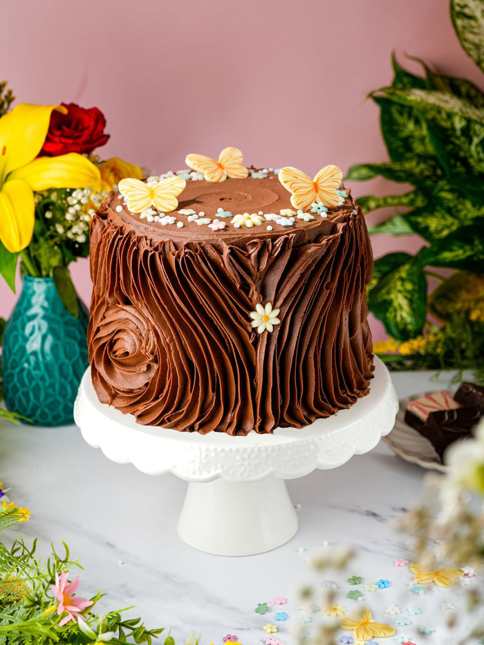 Chocolate Forest Fantasy Cake with rustic chocolate buttercream, sugar butterflies and blossom sprinkles