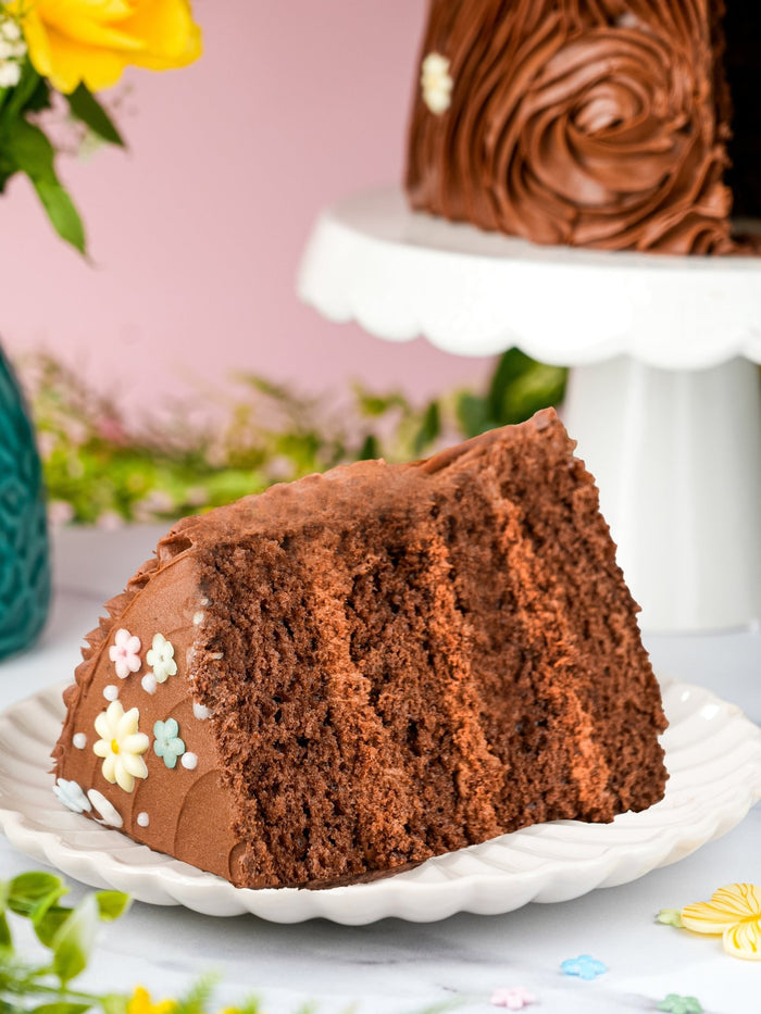 Slice of chocolate fantasy cake showing four layers of chocolate sponge and buttercream
