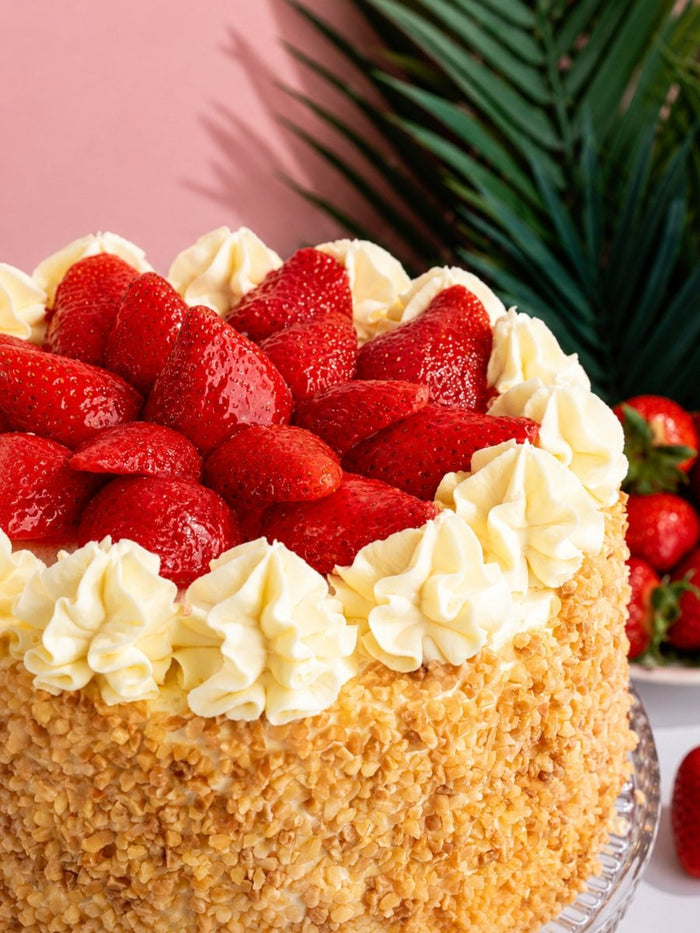 Close view of the fresh strawberries and piped cream on top of the Classic Strawberry Gateau