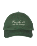 Green cap with 'Cookbooks Are For Reading' text on a white background