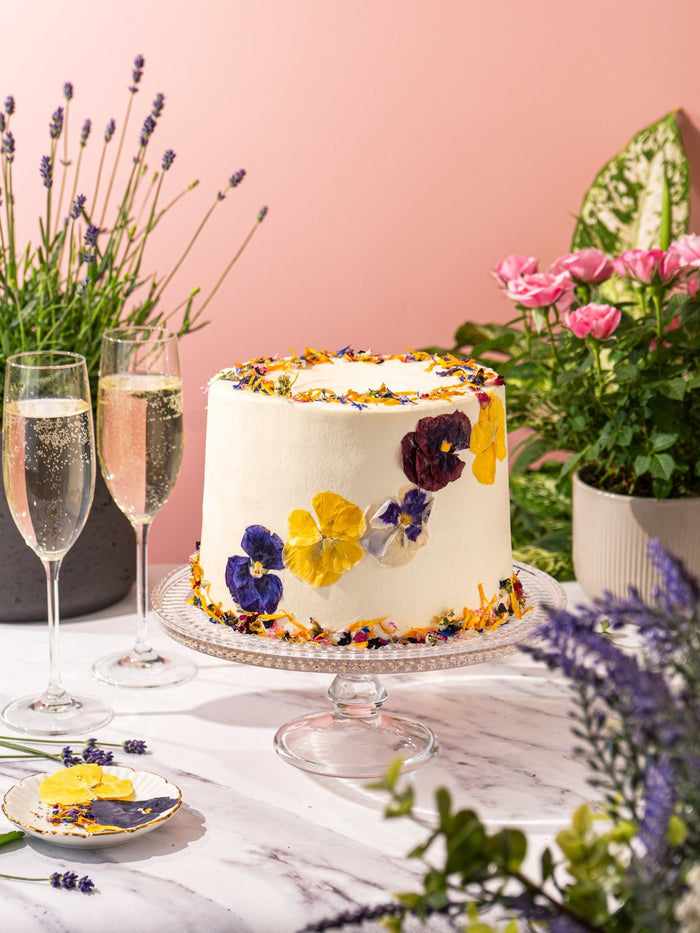 Elderflower and Rose Garden Cake decorated with pressed edible flowers and petals