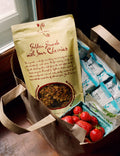 Packaged food items including a bag labeled 'Golden Granola with Sour Cherries' and strawberries in a box.