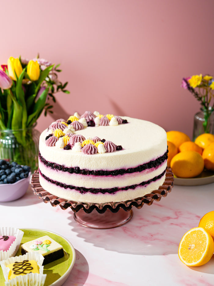 Lemon and Blueberry Dream Cake with blueberry compote layers and piped lemon cream on top