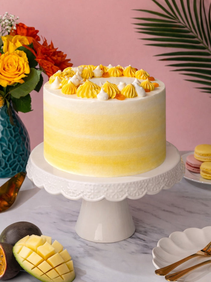 Mango and Passionfruit Cake in yellow ombre buttercream with fresh mango and passionfruit alongside