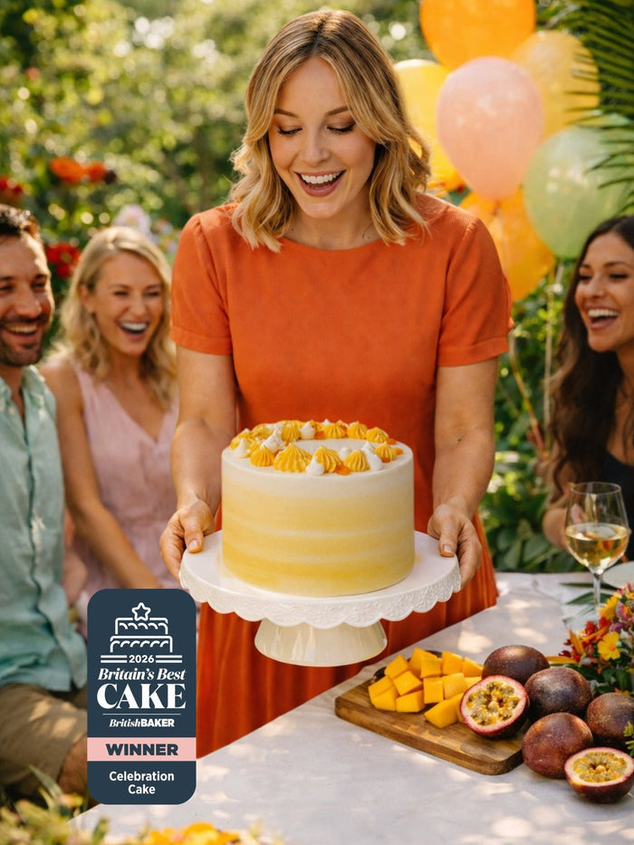 Woman presenting the Mango and Passionfruit Cake, winner of Britain's Best Celebration Cake 2026