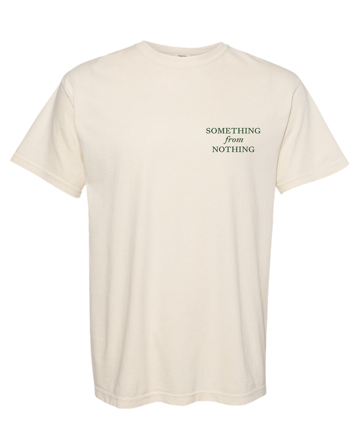 Beige t-shirt with 'SOMETHING from NOTHING' text on a white background