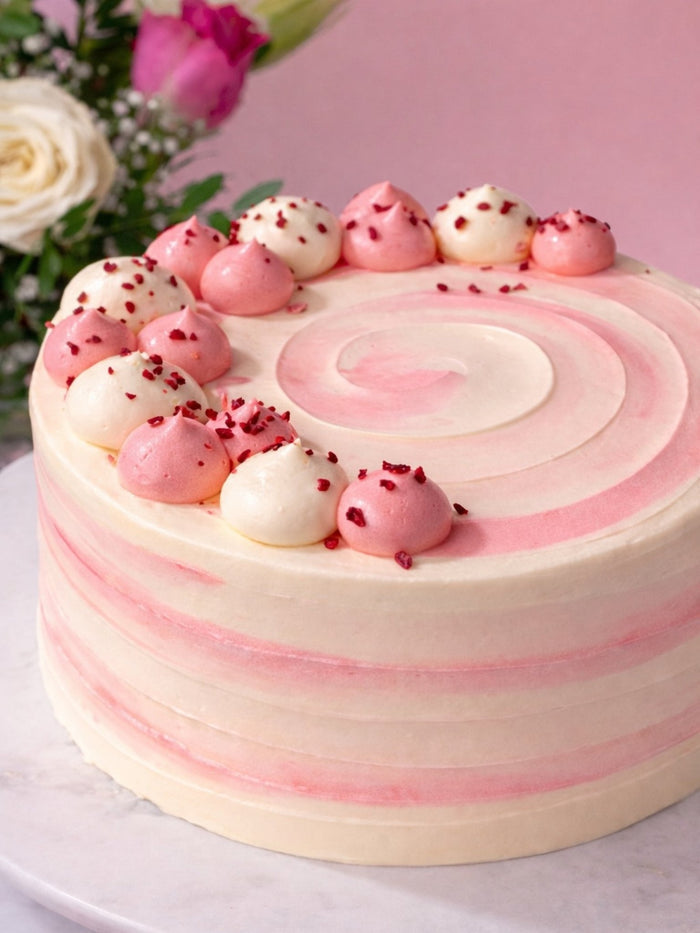Close view of the pink rippled buttercream and piped domes on the Ultimate Raspberry Ripple Cake