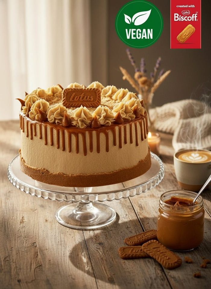 Whole vegan Biscoff cake with caramel drip and piped topping, labelled vegan and made with Lotus Biscoff