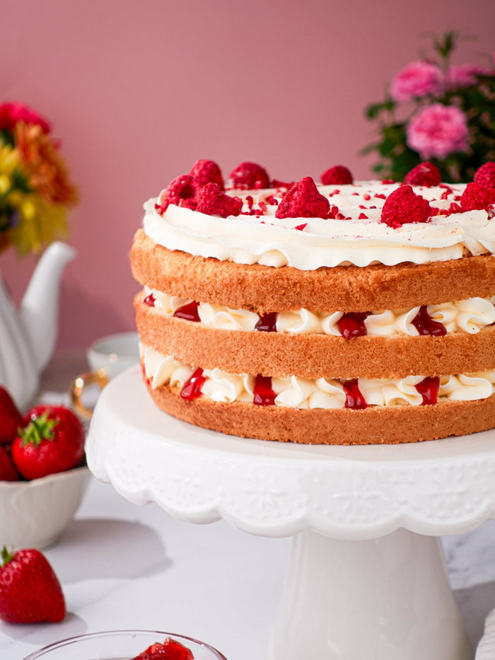 Close view of the Victoria sponge showing cream and strawberry jam between golden sponge layers