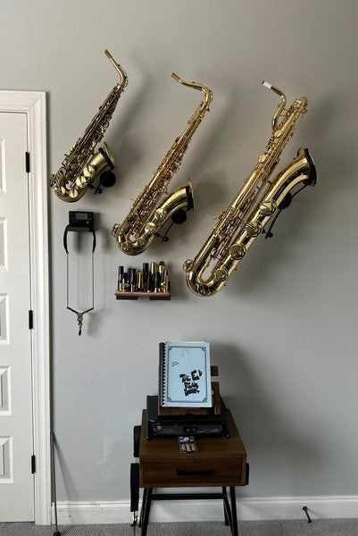 hallway with several saxophones mounted in wall stands